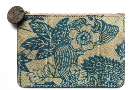 A clutch bag made from fish skin and decorated with blue floral patterns.