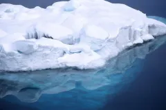 Looking through this iceberg's reflection in the Antarctic water, you can see the iceberg below the surface—some 90% of its total volume. 