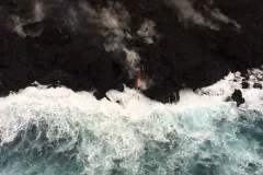 An aerial view of the Hawaii's shore with lava flowing into the ocean from Kilauea volcano.