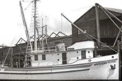 Black and white image of the Western Flyer boat at dock.