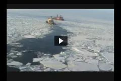 Screenshot from video of a ship amidst broken up ice. 